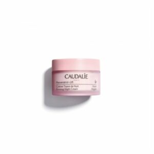 Rosafarbene Nachcreme in runder Glasverpackung mit schwarzer Schrift und Logo, zur Hautstraffung, von Caudalie.