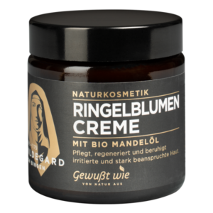 Braunes Glasgefäß mit schwarzem Deckel, gefüllt mit Ringelblumencreme für empfindliche Haut, mit Bio-Mandelöl.