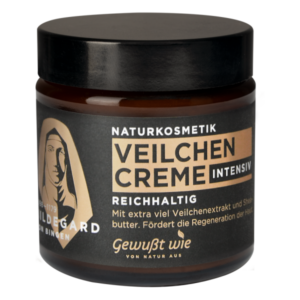 Eine Glascreme-Behälter mit schwarzem Deckel, beschriftet mit "Veilchen Creme intensiv" und Informationen zur Naturkosmetik.