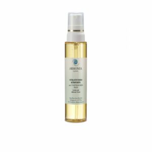 Flasche mit straffendem Körperöl von Armonia, transparent, mit Pumpmechanismus und goldenen Akzenten.