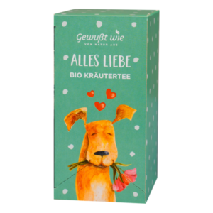 Verpackung von Bio-Kräutertee mit einem lächelnden Hund und Herzen auf grünem Hintergrund.