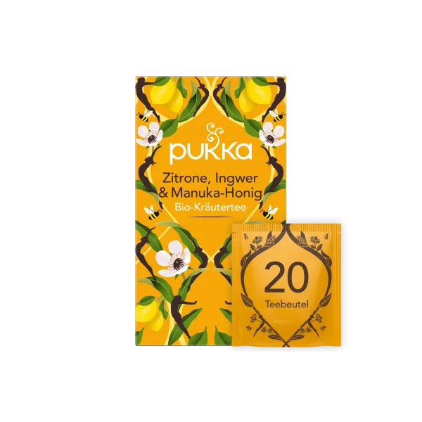 Verpackung von Pukka Bio-Kräutertee mit Zitrone, Ingwer und Manuka-Honig in leuchtend gelber Box und Teebeutel.