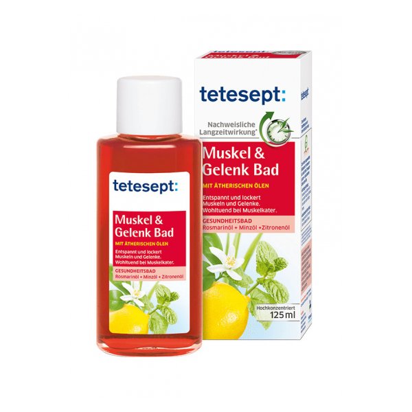 Flasche mit roten Inhalt für Muskel- und Gelenkbad, verpackt in einer beschrifteten Schachtel mit Pflanzenmotiven.