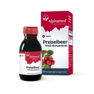 Flasche mit Preiselbeer-Trinkkonzentrat, verpackt in einer rot-weißen Box, als Nahrungsergänzungsmittel.