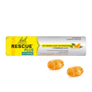 Verpackung mit Vitamin-B5- und B12-Bonbons in orangefarbener Hülse, zwei Bonbons sind sichtbar.