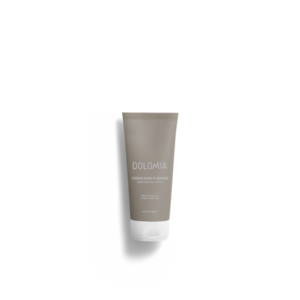 Tube mit Hand- und Nagelcreme von Dolomia in neutralen Farben, Inhaltsangaben auf der Vorderseite.