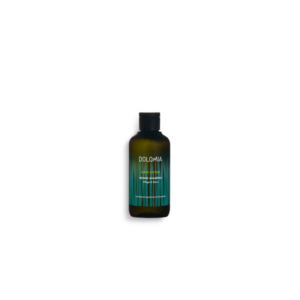 Schwarze Flasche mit grünem Farbverlauf, beschriftet mit "Dolomia Hair Detox Repair-Shampoo".