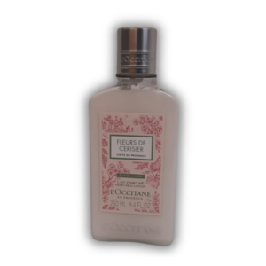 Flasche mit parfümierter Lotion von L'Occitane, mit rosafarbenem Etikett und Silberverschluss.