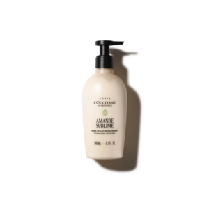 Flasche mit Pumpspender, enthält L'Occitane Amande Sublime Quenching Milk Veil für die Körperpflege.