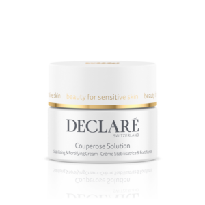 Glänzender Behälter mit einer stabilisierenden Creme für empfindliche Haut, beschriftet mit "Couperose Solution" und goldener Akzentlinie.