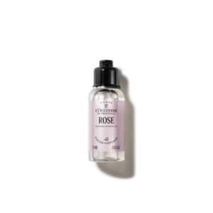 Transparente Flasche mit rosa Duschgel von L'Occitane, mit schwarzem Deckel und dekorativem Label.